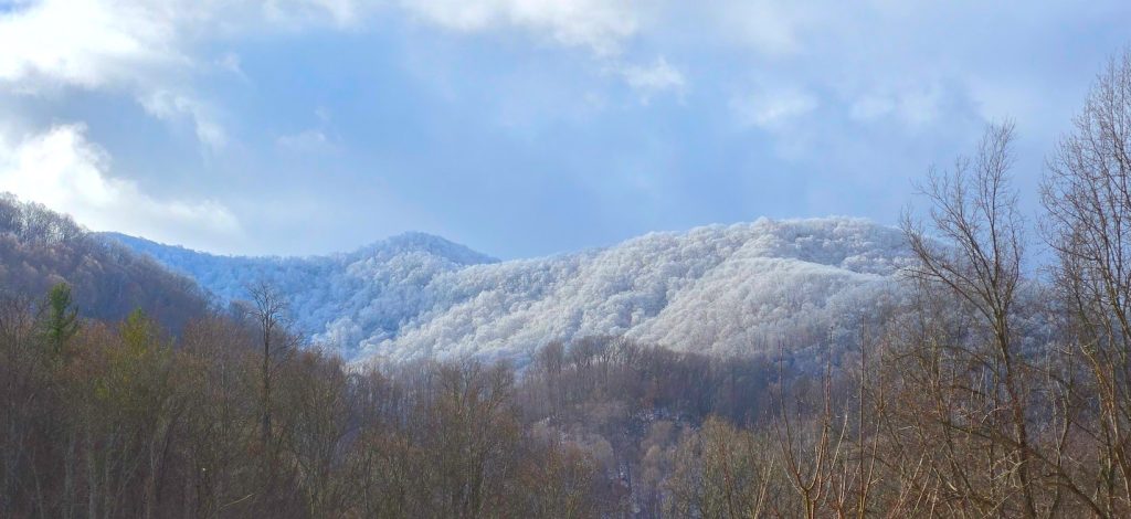 Blue Ridge Mountains with snow caps and a blue sky