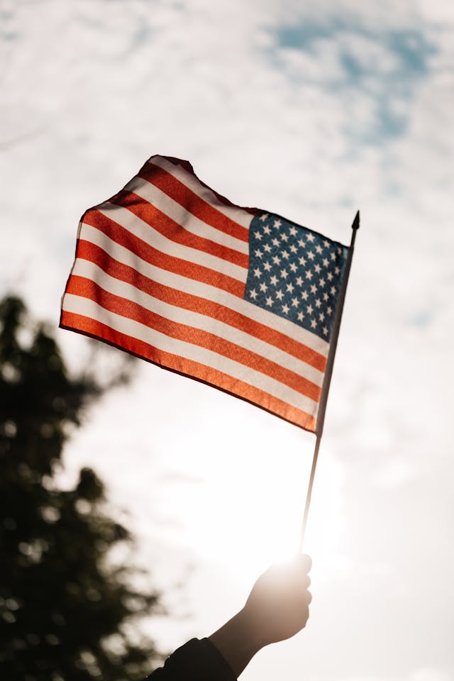 hand waving American flag photo credit: Photo by Photo By: Kaboompics